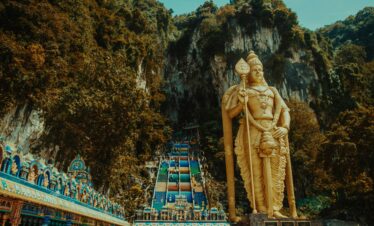 Majestic statue of Lord Murugan at Batu Caves, a famous tourist destination in Malaysia.