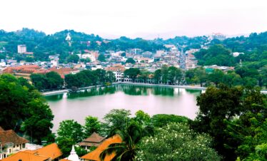 A picturesque view of Kandy city with its lush landscapes and serene lake, Sri Lanka.