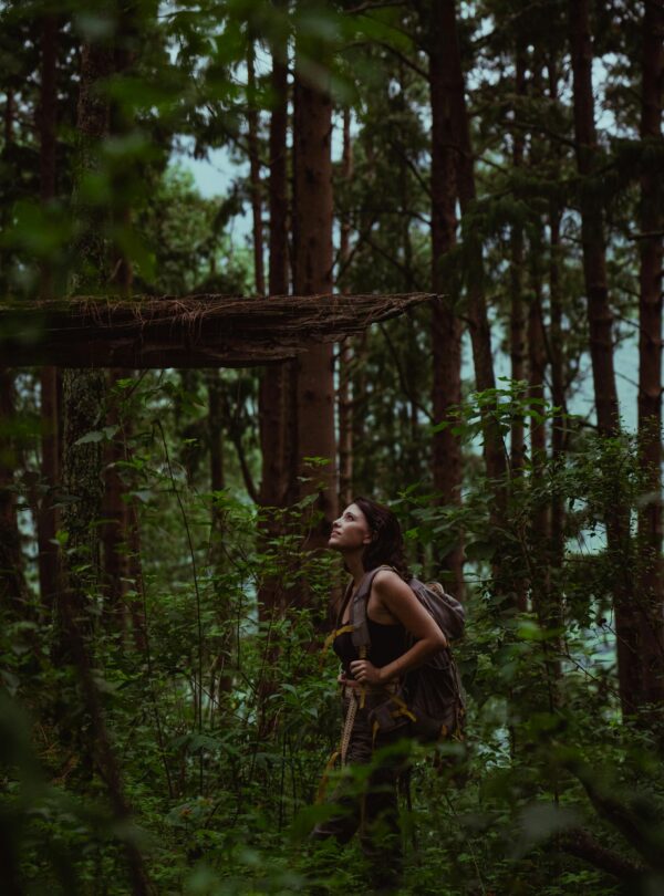 A woman enjoys hiking through the dense, green forest of Yala, Argentina, exploring nature.